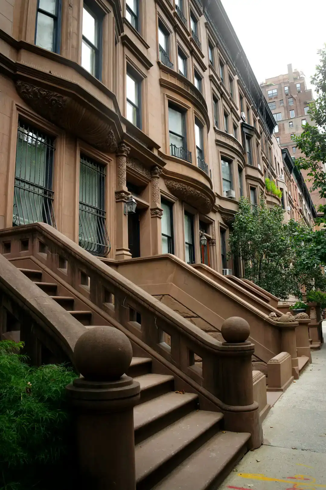 Row of brownstone houses with stone stoops