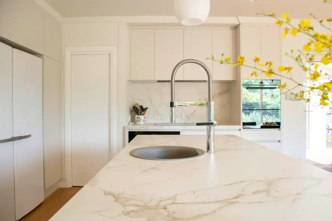 Kitchen faucet over a stainless steel sink