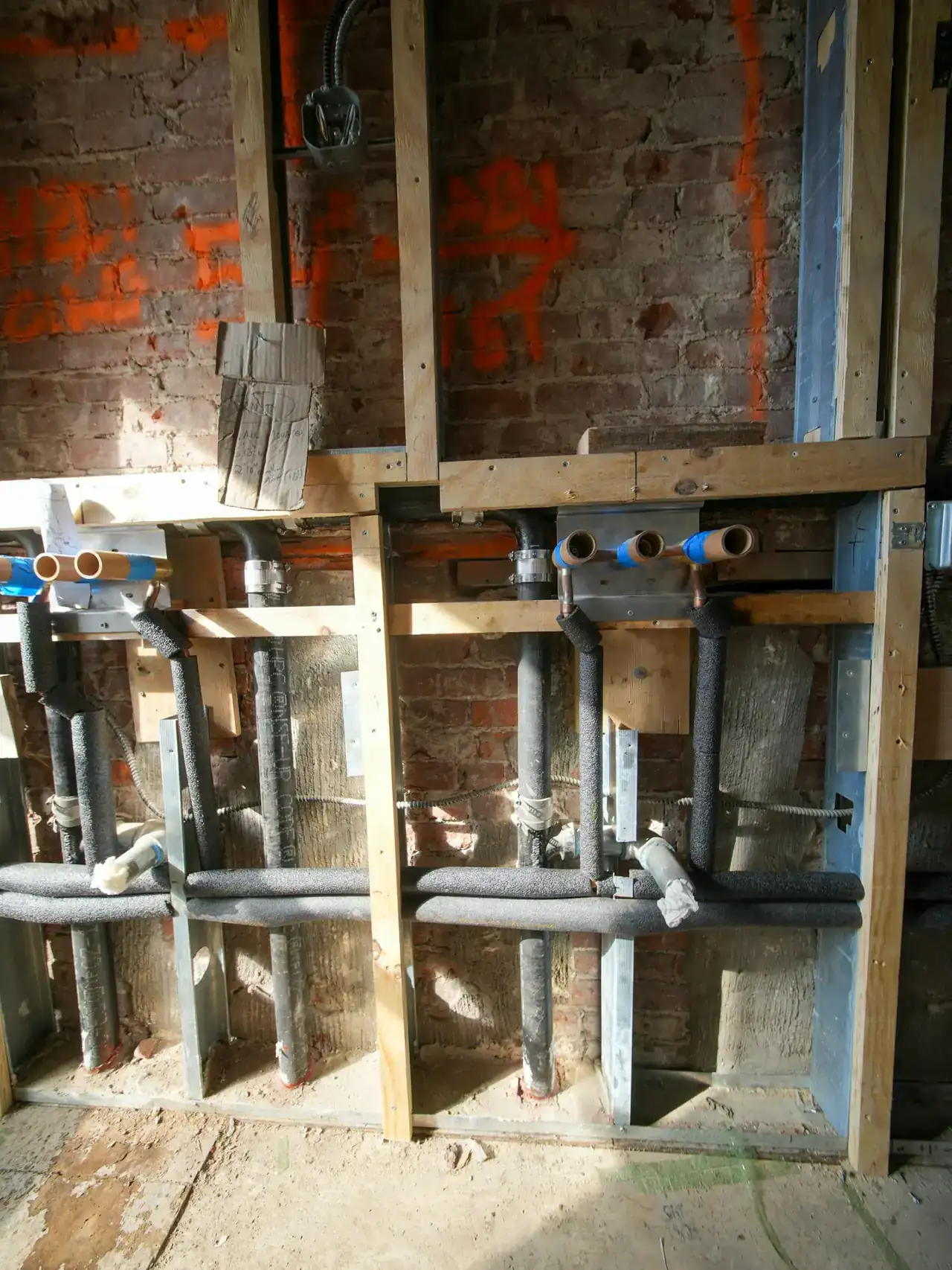 New plumbing pipes running through an open wall